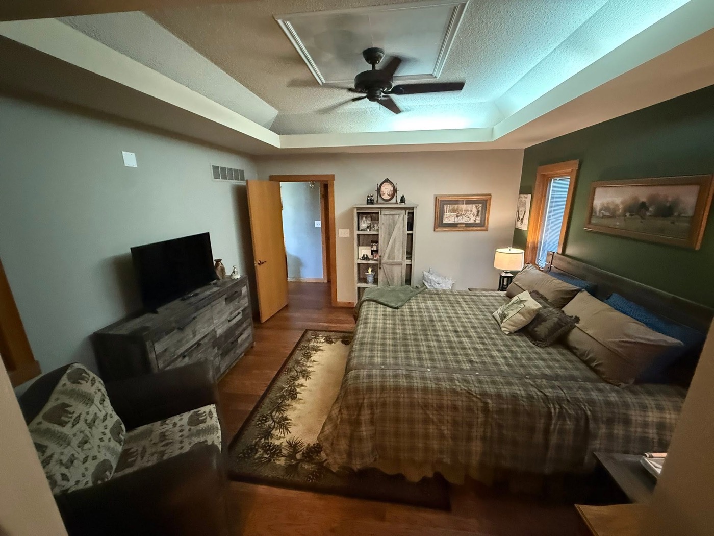Master bedroom with deep green accent walls